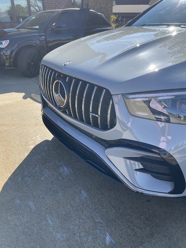 Front end of a silver Mercedes-AMG on a driveway after detailing