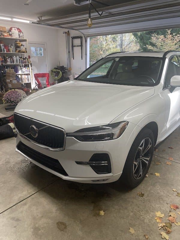 White Volvo XC60 parked in a garage after detailing