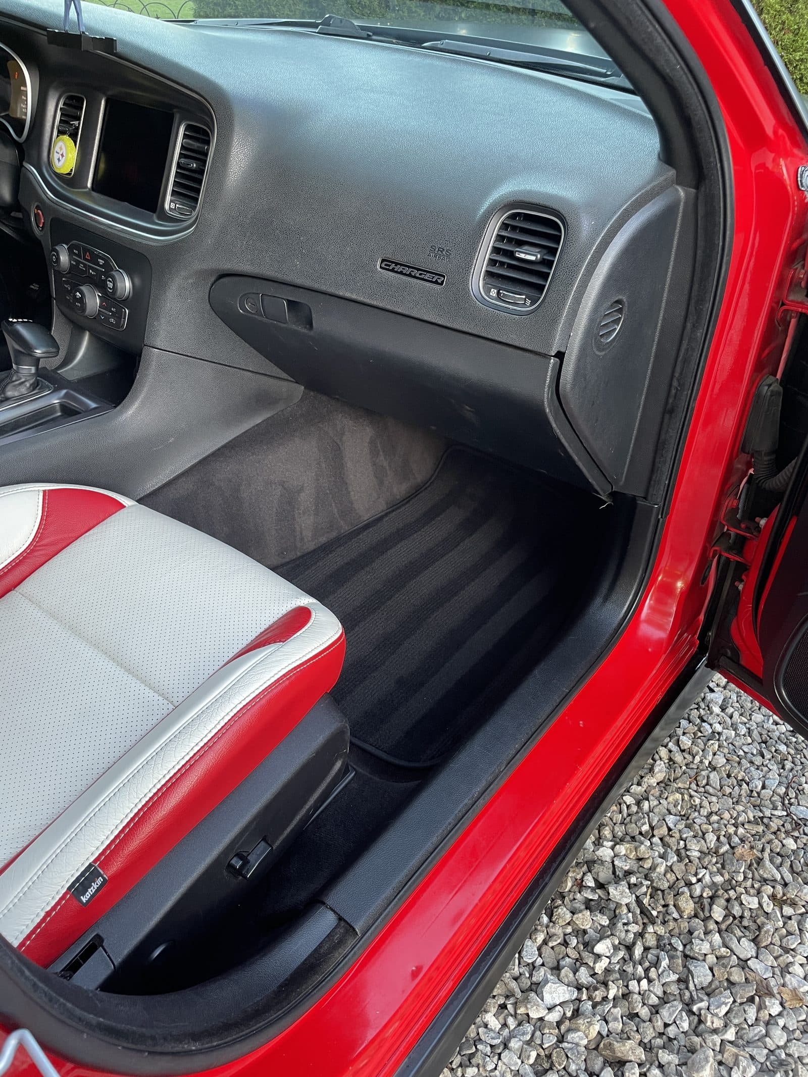 Red and white interior of a Dodge Charger with the door open