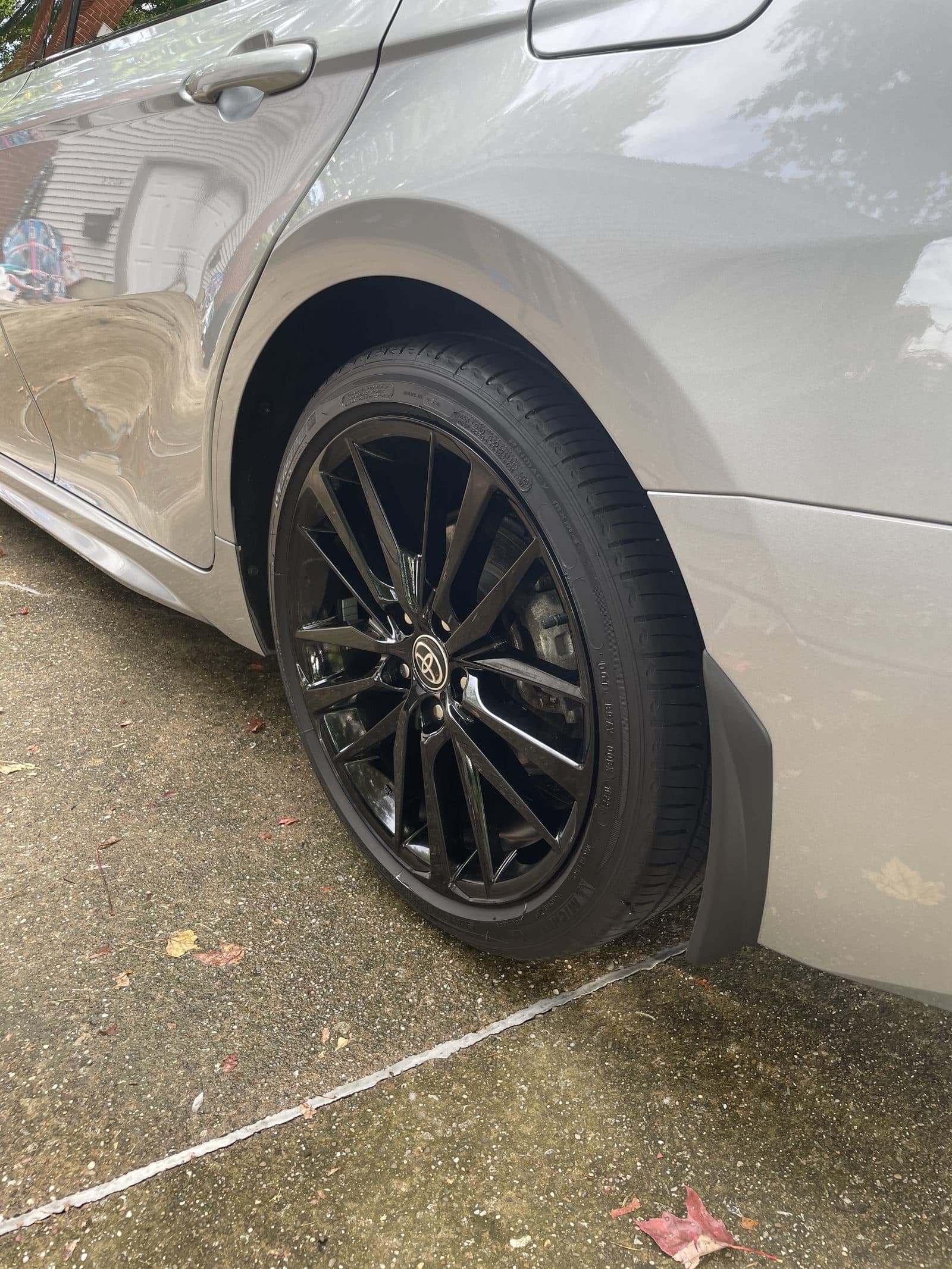 Rear wheel and quarter panel of a silver Toyota after detailing