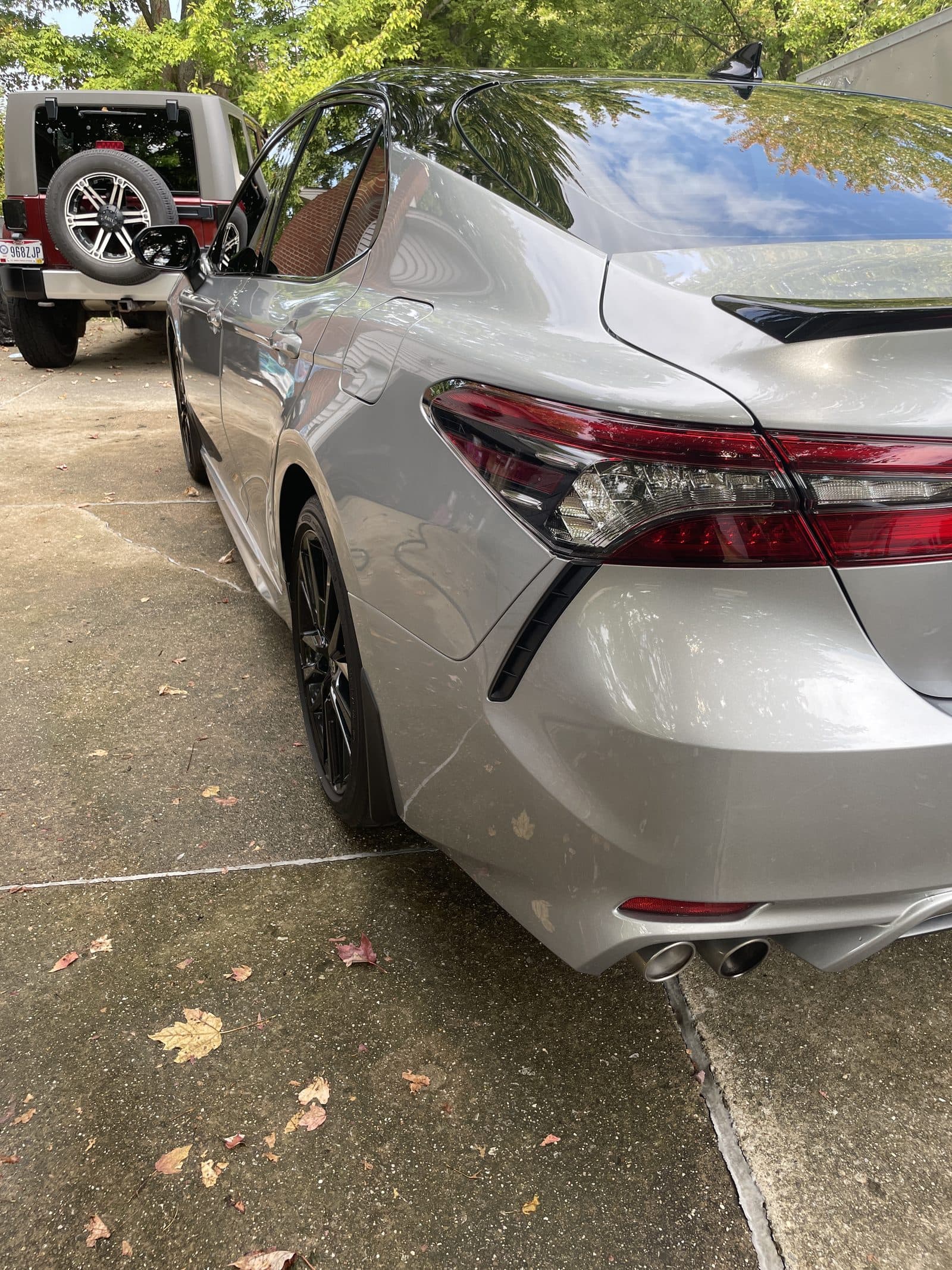 Rear of a silver Toyota Camry on a driveway after detailing
