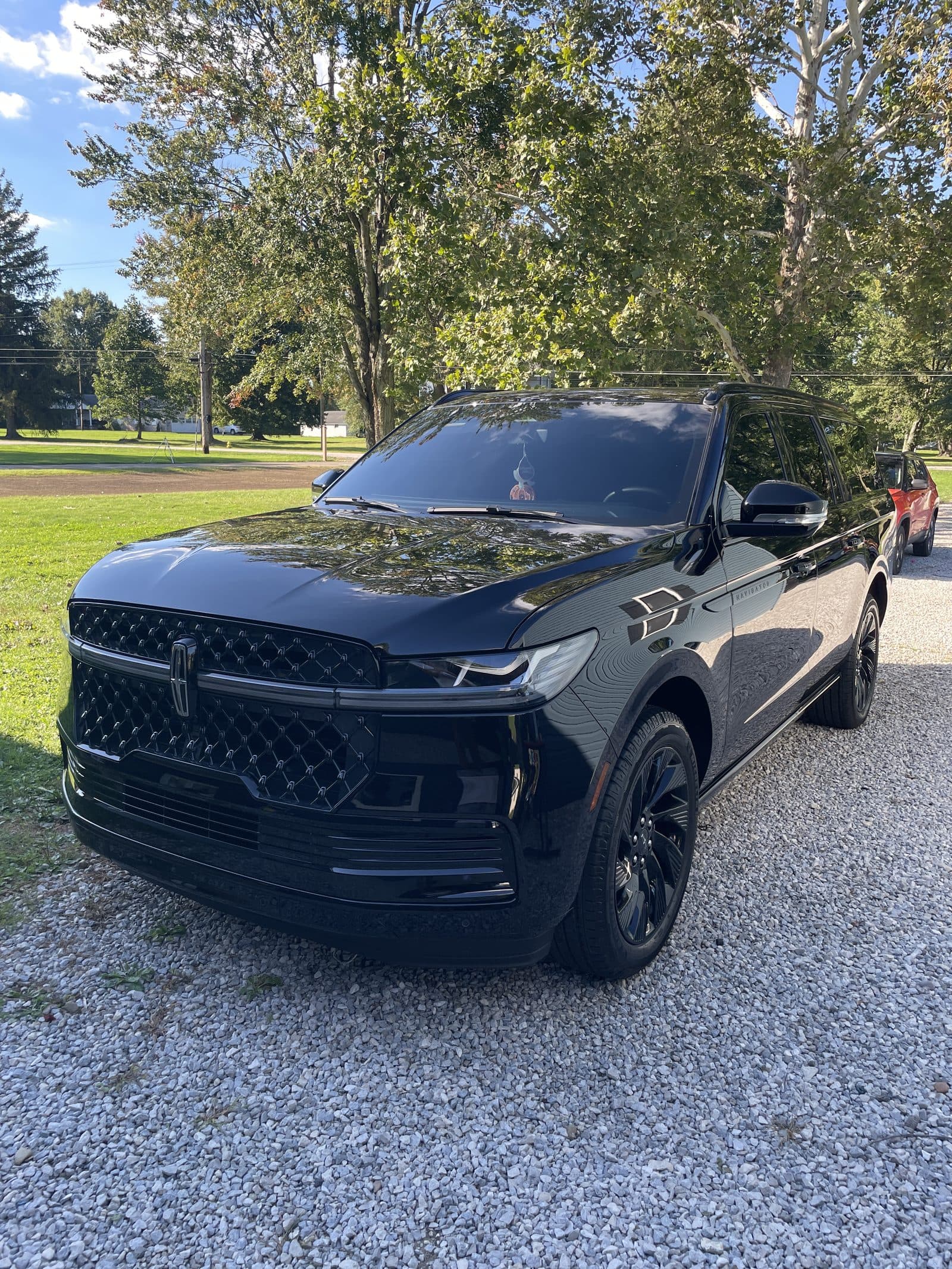 Black Lincoln Navigator on a gravel driveway after detailing