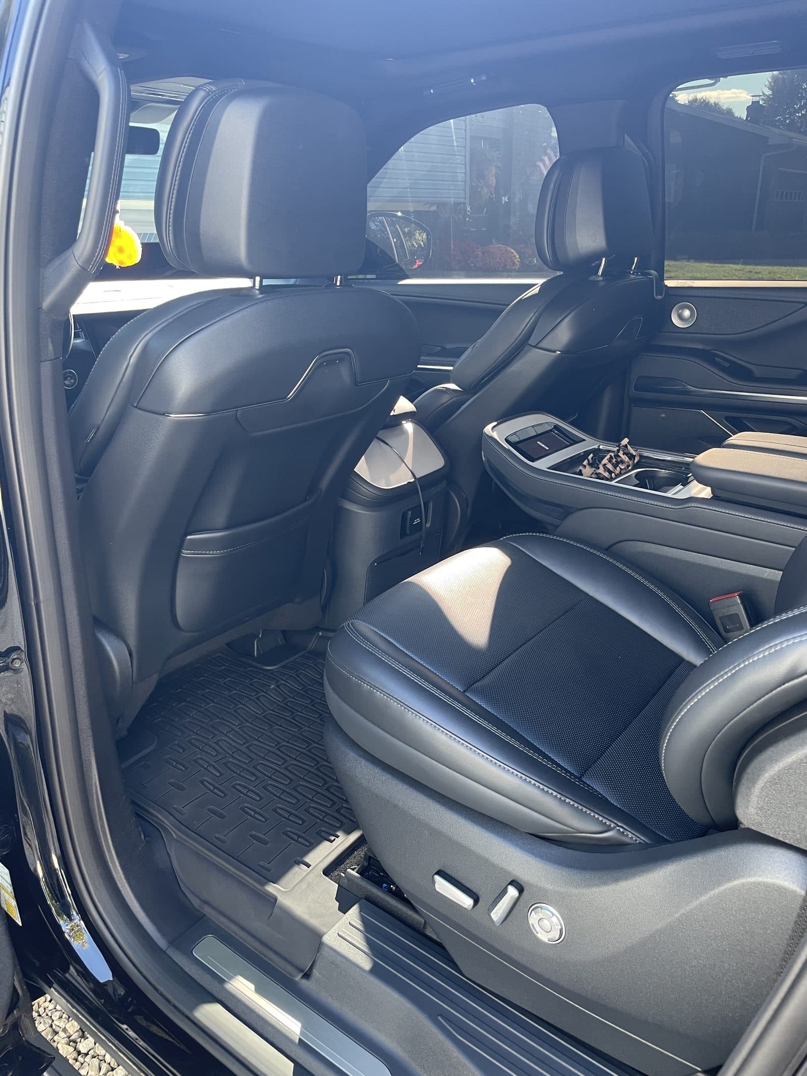 Clean second-row seat and floor mat of a Lincoln Navigator after detailing