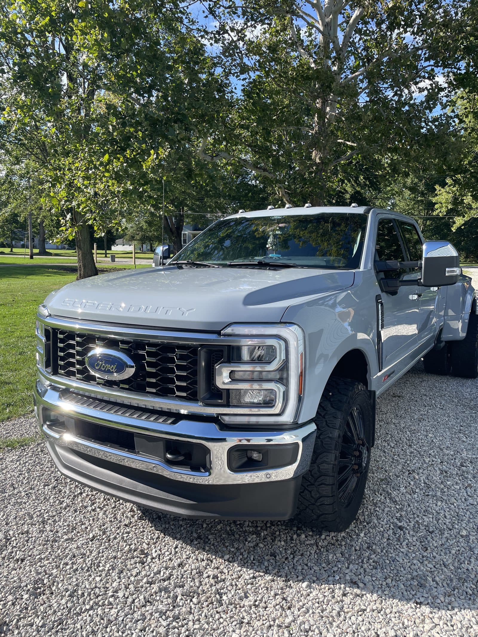 Gray Ford F-350 pickup on a gravel driveway after detailing