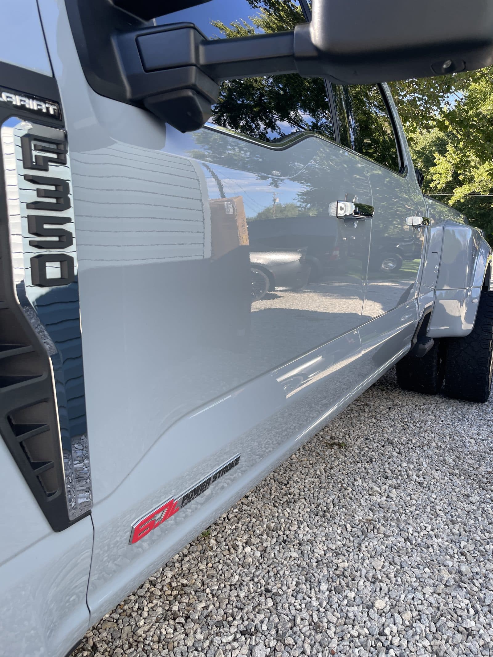Door panel and F350 badge of a gray Ford pickup after detailing